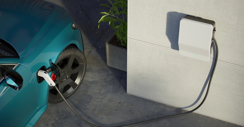 An ev charger hooked up to a car charging it. 