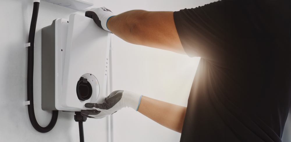 A man installing an ev charger