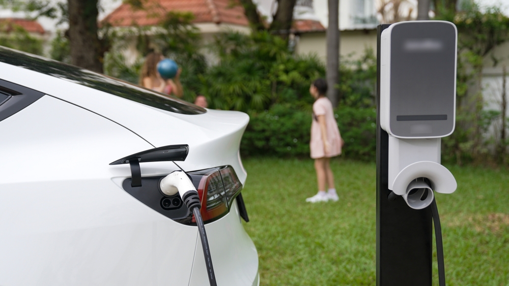 Electric,Vehicle,Recharge,From,Home,Charging,Station,On,Background,Of
