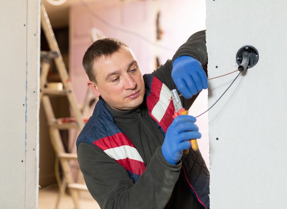 Repairman,Cutting,Wires,With,Pliers,In,Domestic,Interior,Closeup