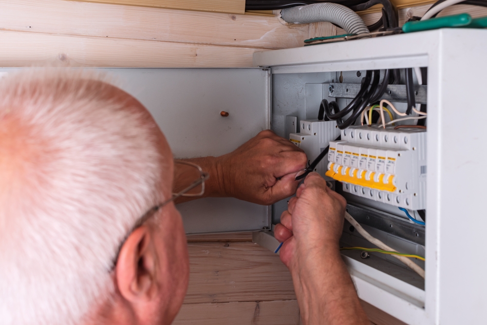 An,Experienced,Electrician,Carefully,Connects,Wires,In,A,Modern,Electrical