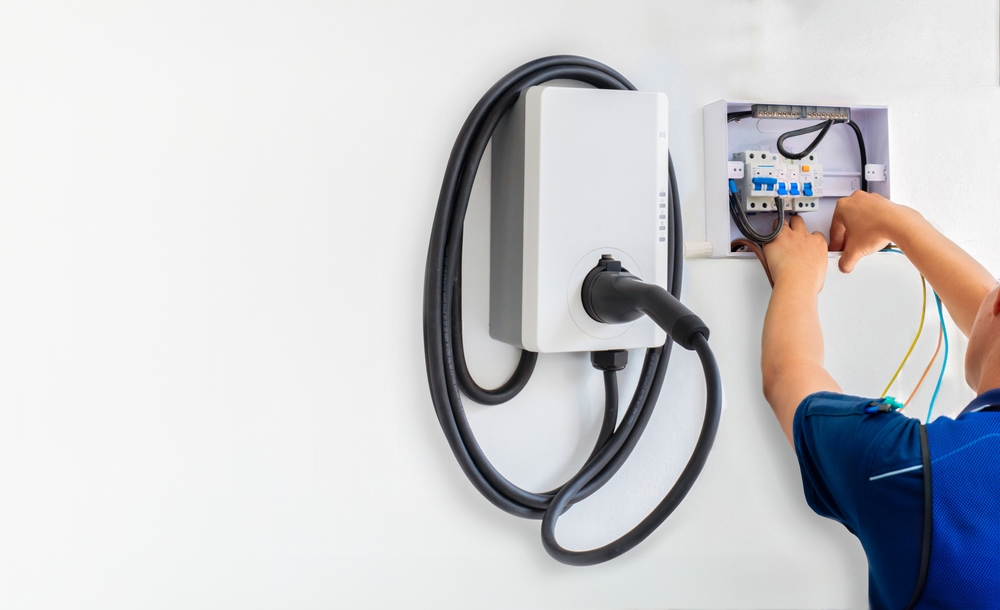 A man installing an EV Charger